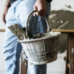 Handyman Holding Basket Cement For Construction