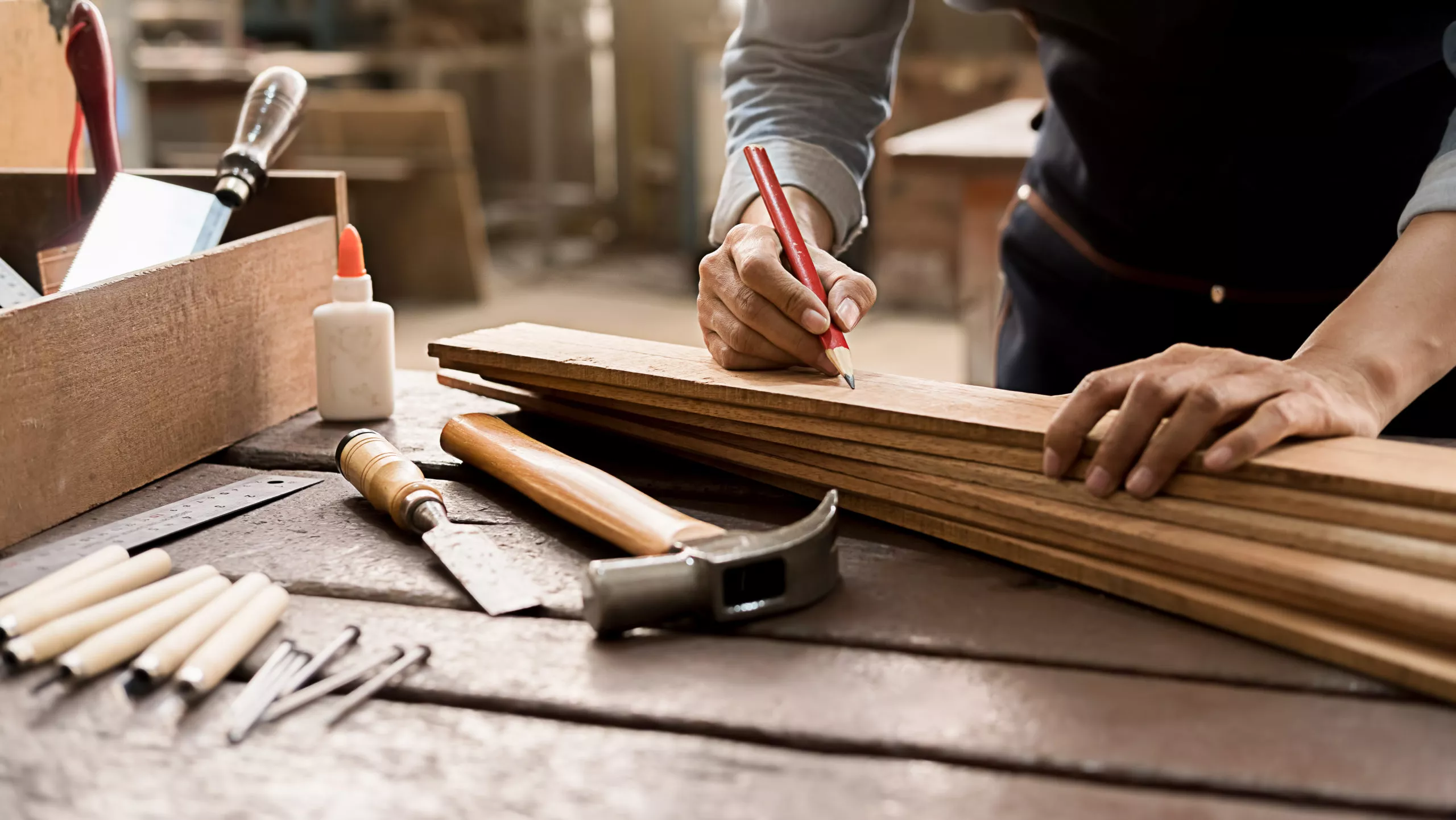 Carpenter Working With Equipment On Wooden Table In Carpentry Shop. Woman Works In A Carpentry Shop.