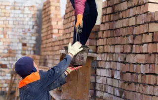 Worker Builds A Brick Wall In The House