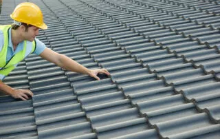 Builder Working On Roof Of New Building