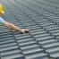 Builder Working On Roof Of New Building